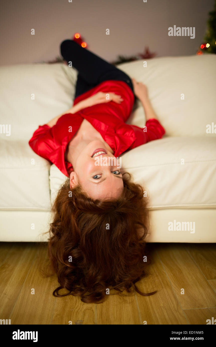 Pretty redhead lying on the couch Stock Photo
