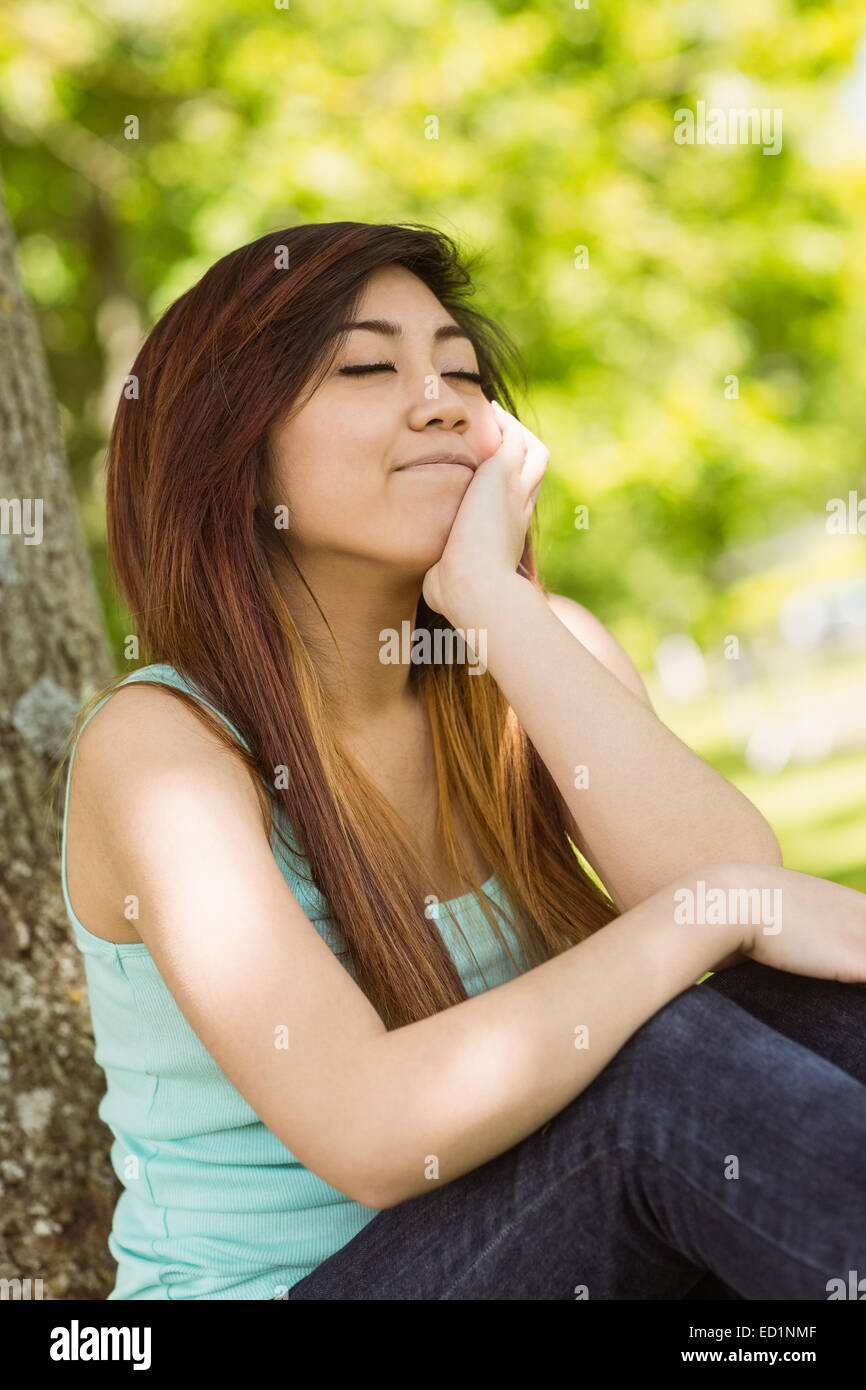 Beautiful woman with eyes closed in park Stock Photo - Alamy