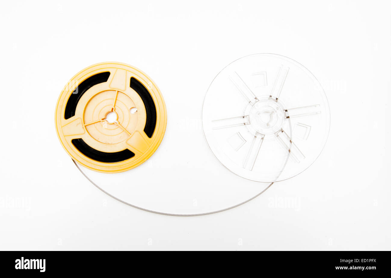 Empty transparent and yellow 8mm movie reels on white background