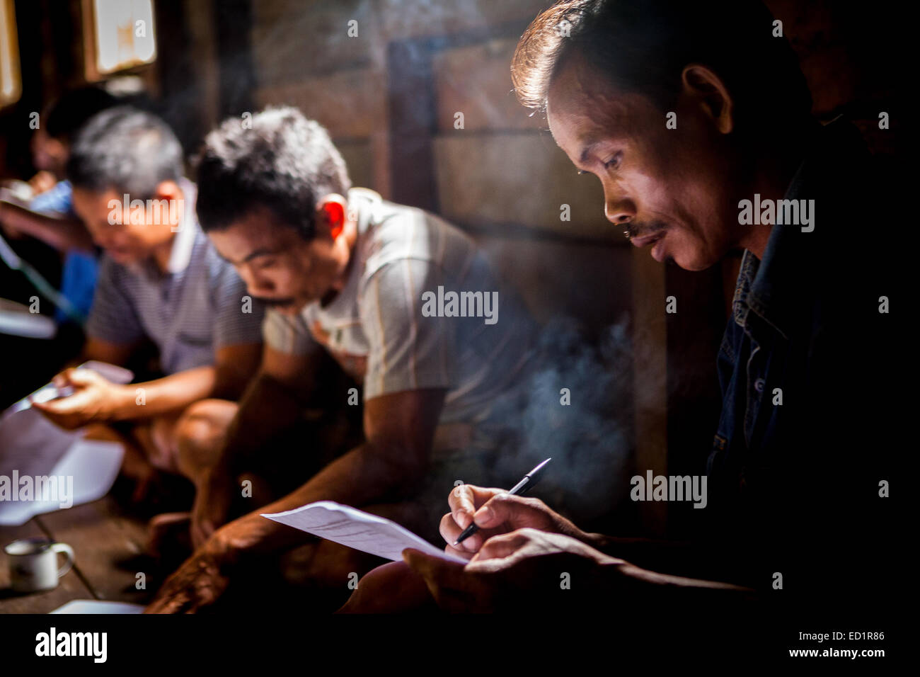 Villagers completing questionnaire on conservation and tourism potential during an ecotourism assessment in remote village of Nanga Raun. Stock Photo