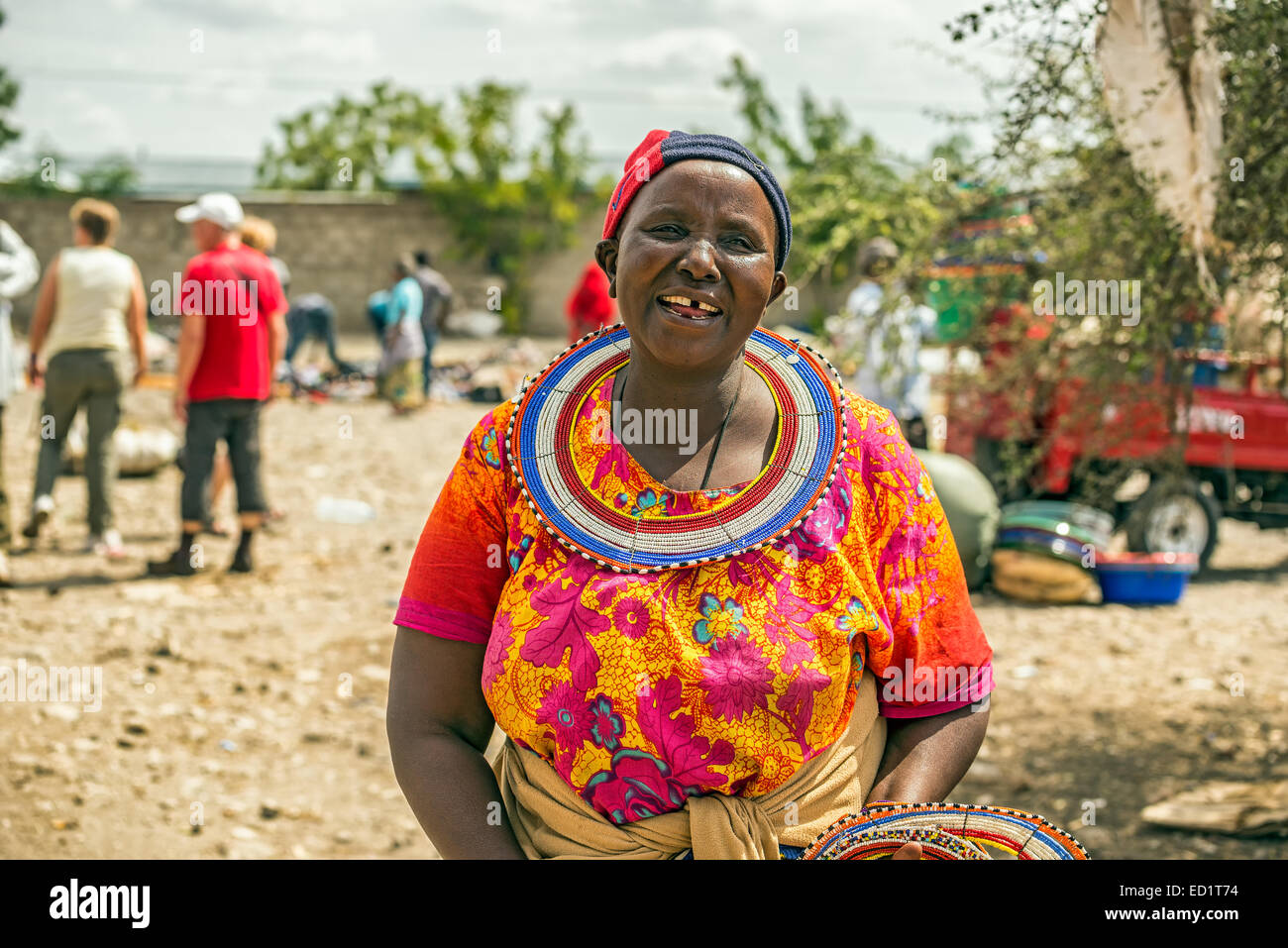 Traditionally dressed african woman from the masai tribe selling merchandise  in the Masai Central Market of Mto Wa Mbu Stock Photo