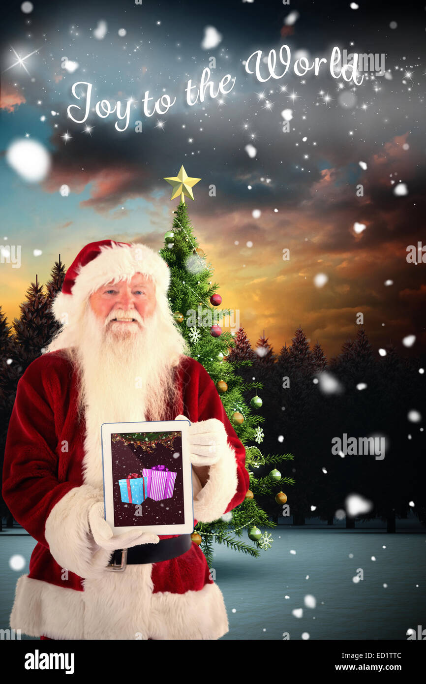 Composite image of santa presents a tablet pc Stock Photo - Alamy
