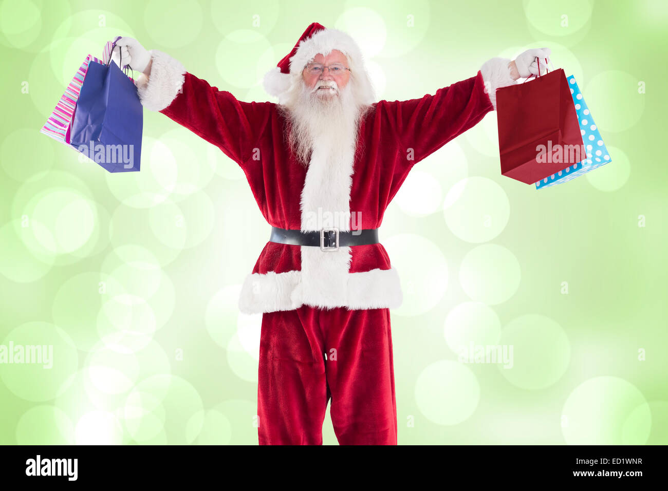 Composite image of santa holds some bags for chistmas Stock Photo - Alamy