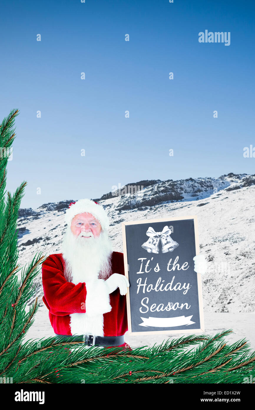 Composite image of santa claus showing blackboard Stock Photo - Alamy