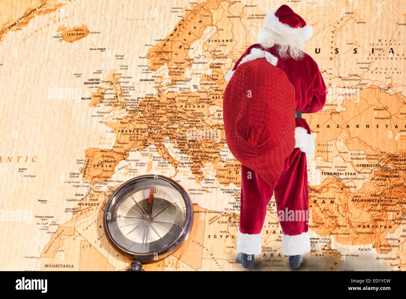 Composite image of santa is holding his bag in one hand Stock Photo - Alamy