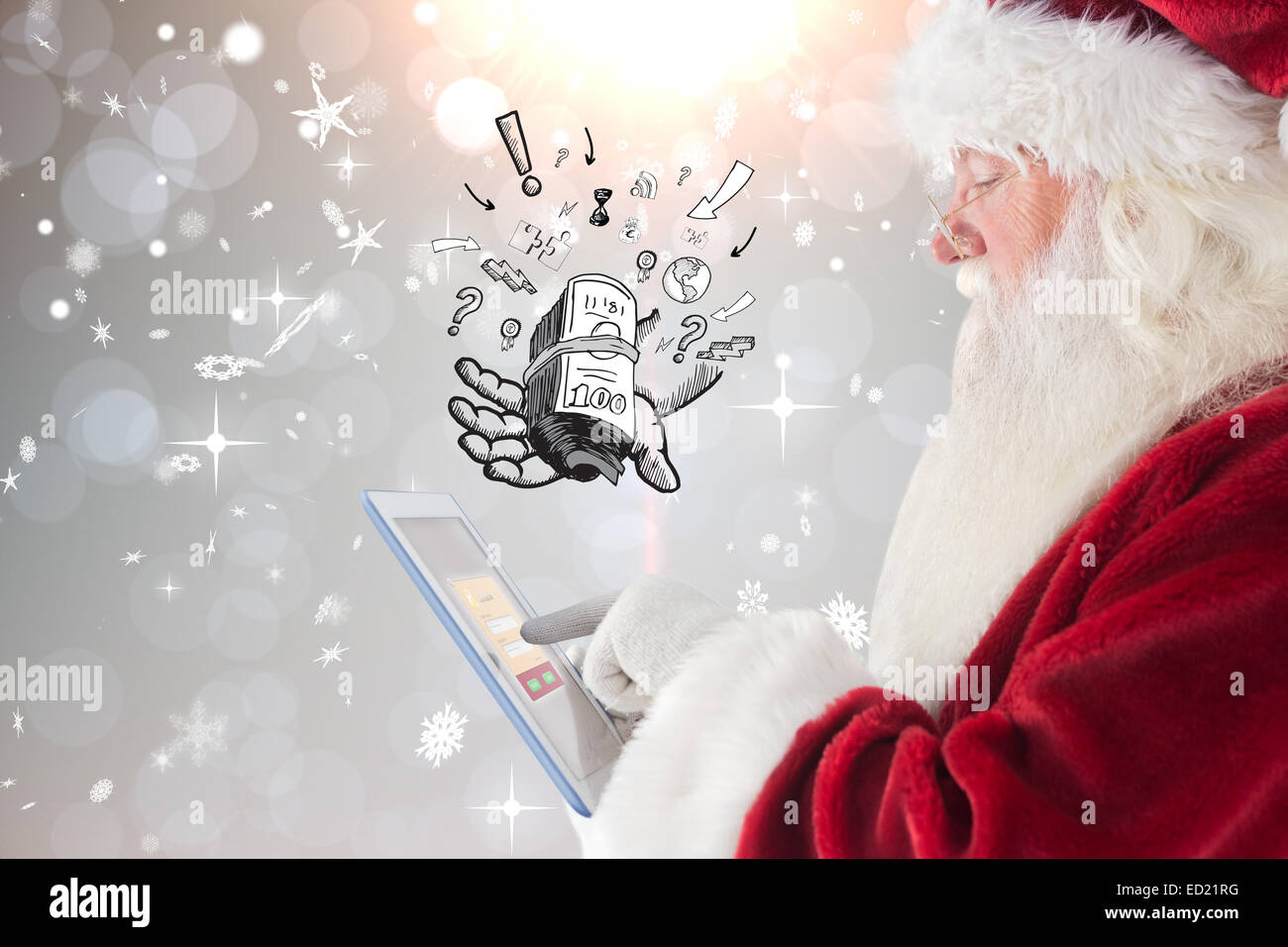 Composite image of santa uses a tablet pc Stock Photo - Alamy