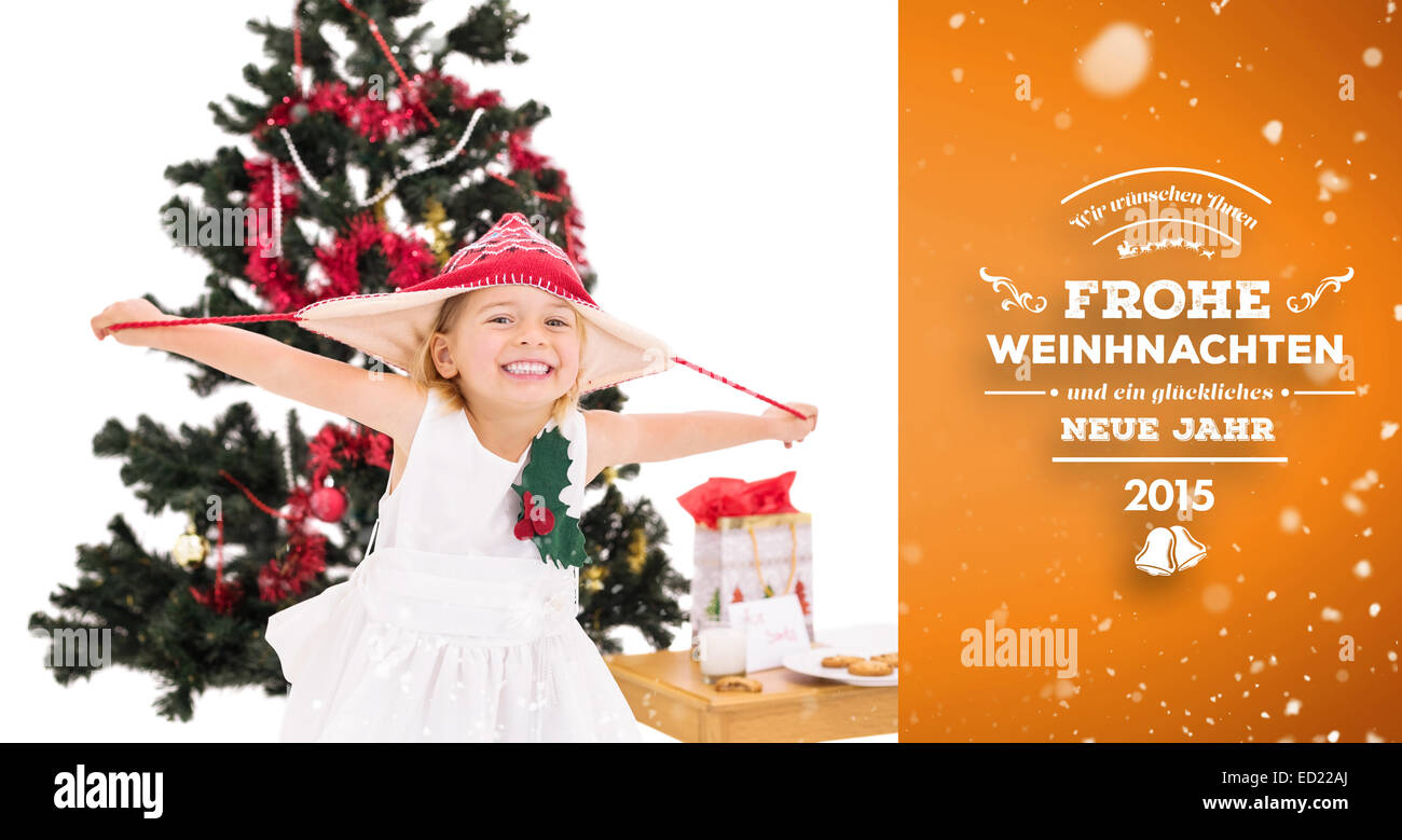 Composite image of festive little girl smiling at camera Stock Photo ...