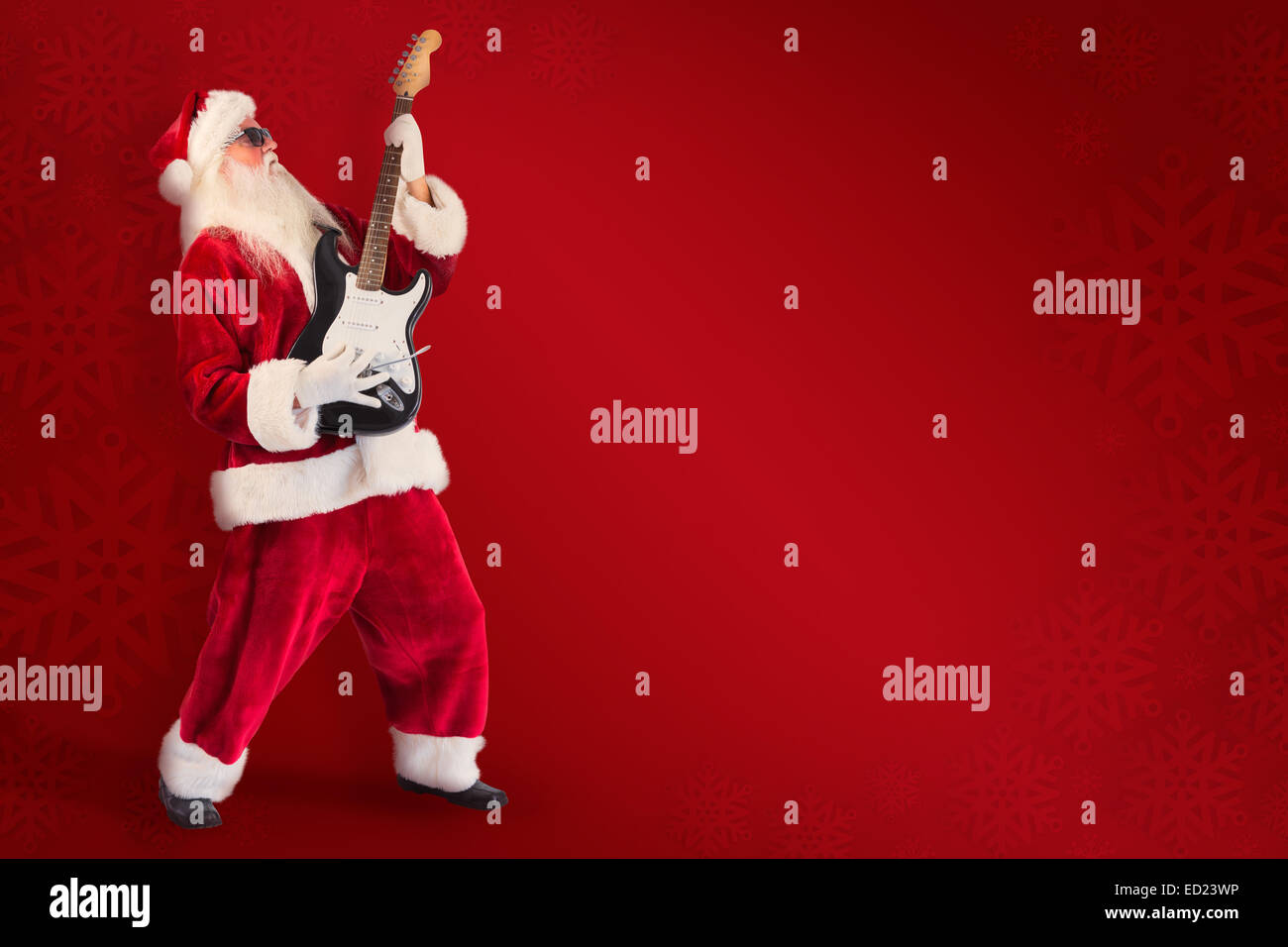 Composite image of santa playing electric guitar Stock Photo