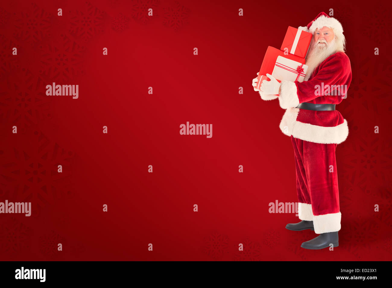Composite image of santa carries a few presents Stock Photo - Alamy