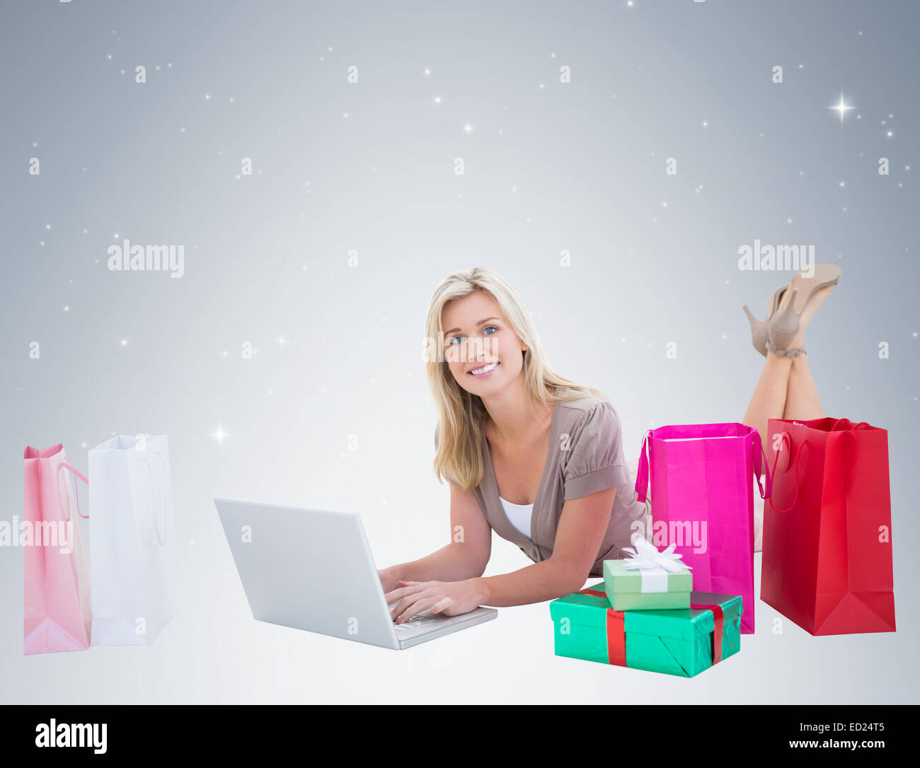 Happy blonde shopping online with laptop Stock Photo - Alamy