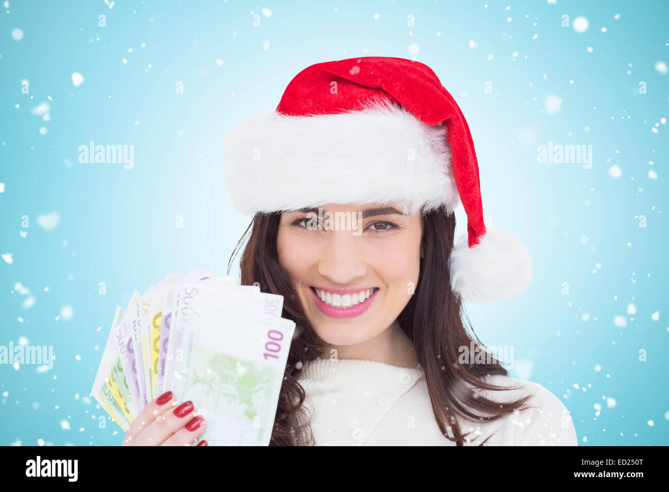 Composite image of happy brunette holding her cash Stock Photo - Alamy