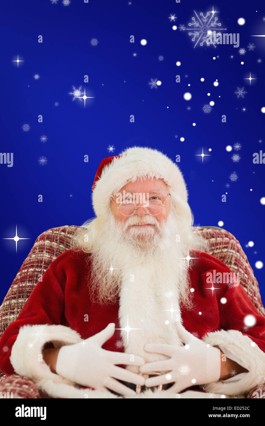 Composite image of santa holding his belly on the armchair Stock Photo ...