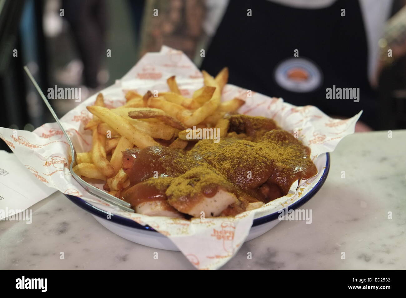 Soho, London, UK. 01st Oct, 2014. Currywurst (curry-flavored bratwurst) and French fries are served in the restaurant 'Herman ze German' in Soho, London, United Kingdom, 01 October 2014. Arts, culture, and luxury goods 'Made in Germany' are en vogue in London. Shortly before Christmas, Londoners are particularly fond of German food. Photo: Marc Schaefer/dpa/Alamy Live News Stock Photo