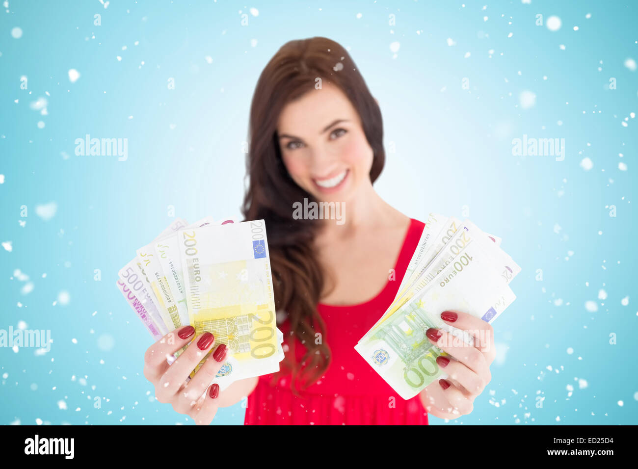 Composite image of cheerful brunette showing her cash money Stock Photo ...