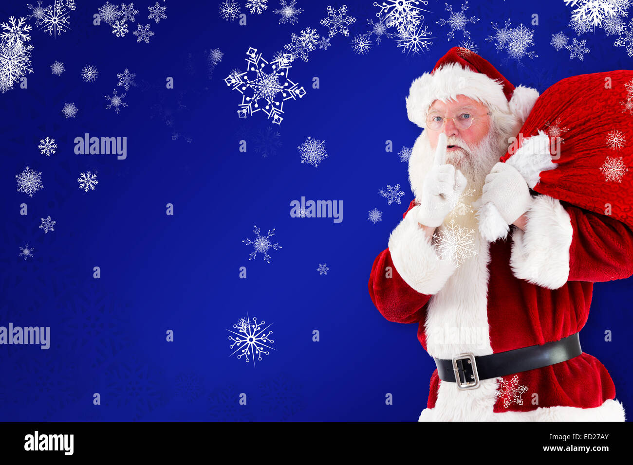 Composite image of santa claus carrying sack Stock Photo - Alamy
