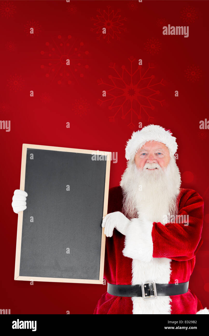 Composite image of santa claus showing blackboard Stock Photo - Alamy