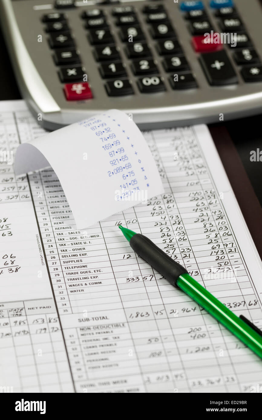 Desktop with calculator, ledger, pencil and tape with numbers Stock Photo