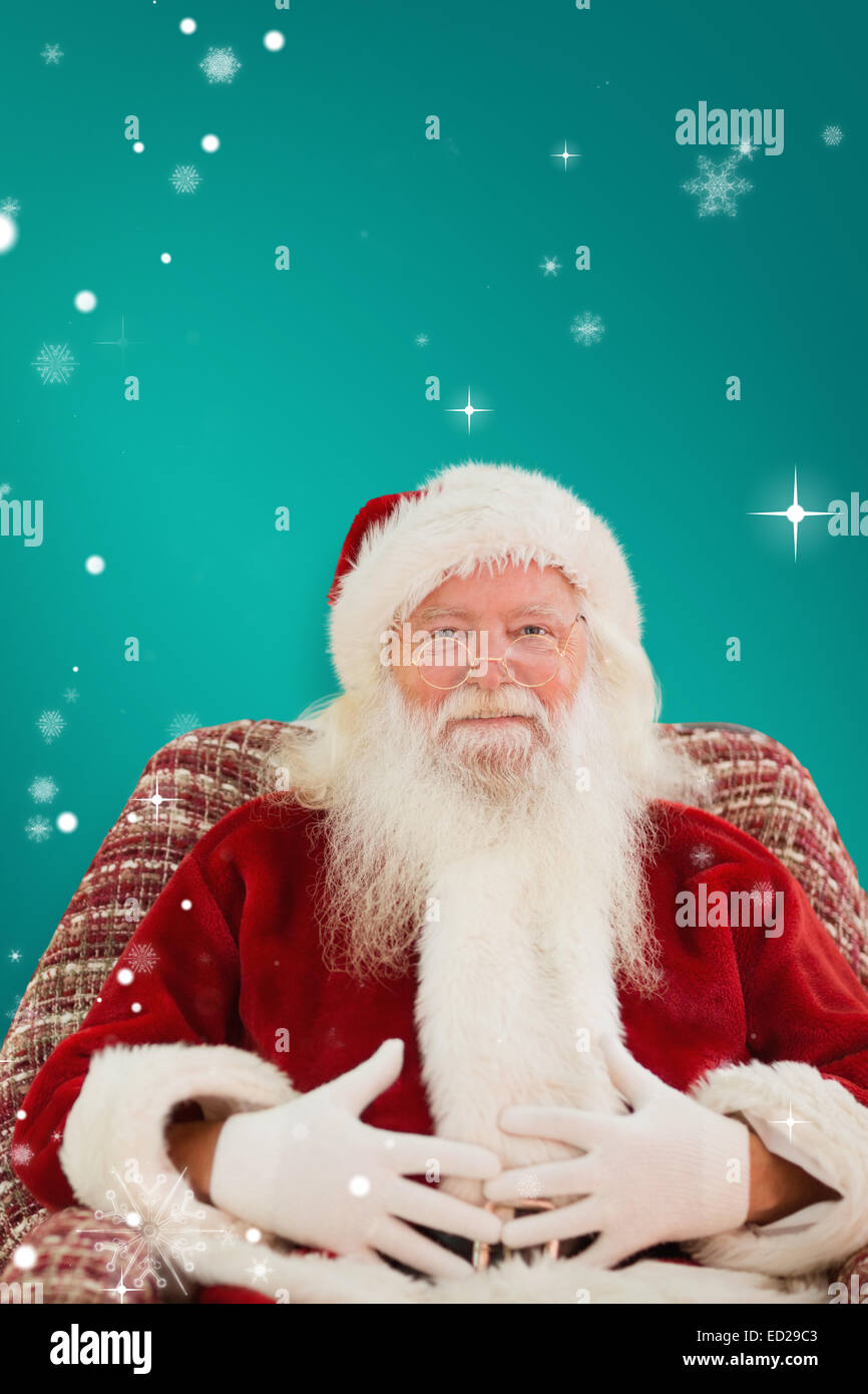 Composite image of santa holding his belly on the armchair Stock Photo ...