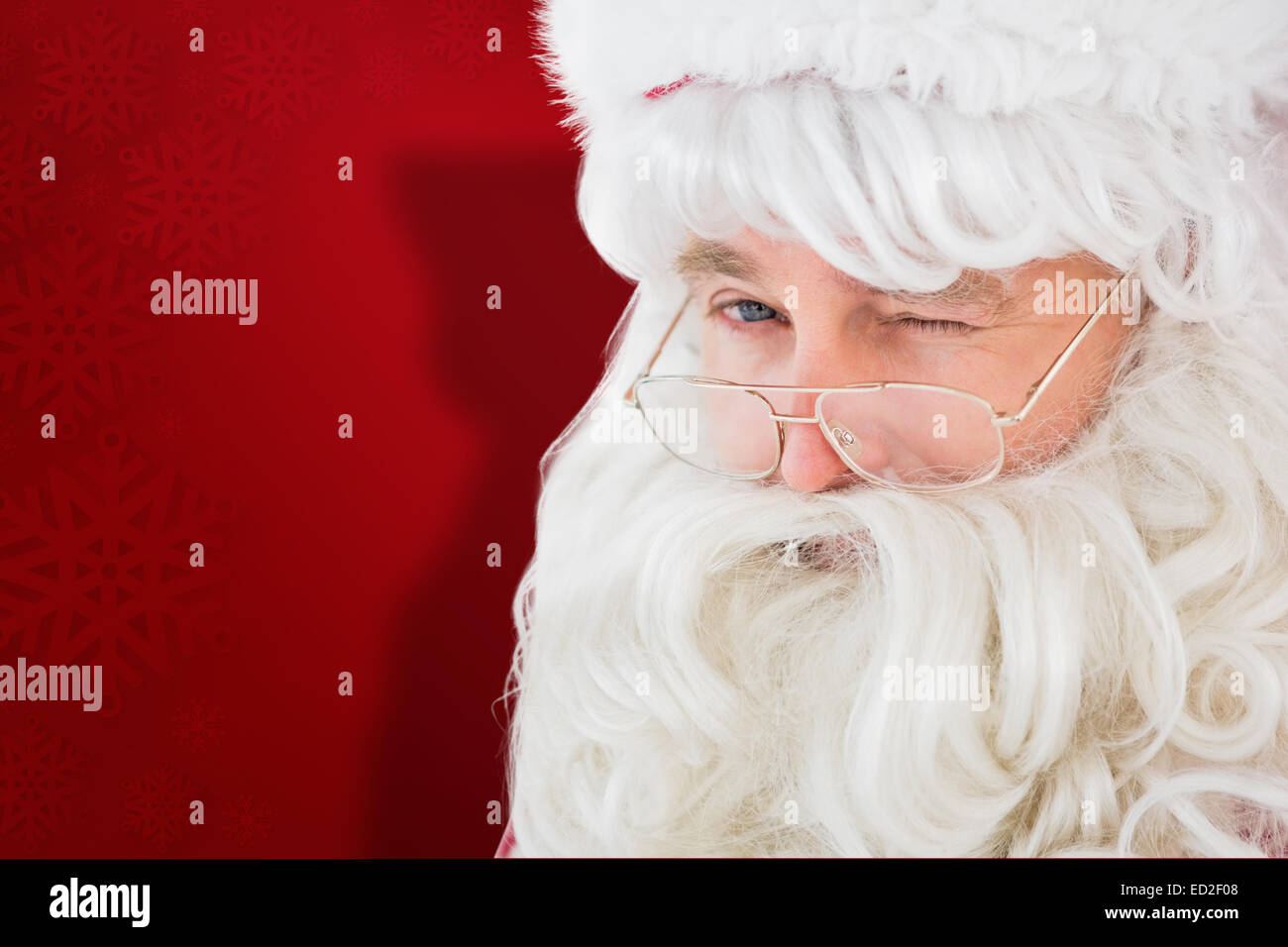 Composite image of portrait of santa claus winking Stock Photo - Alamy