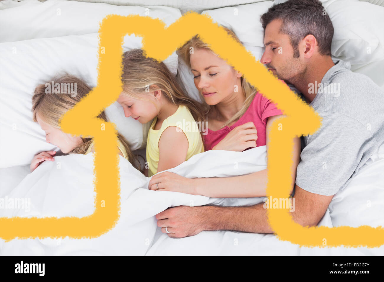 Composite image of parents sleeping in bed with their twins Stock Photo