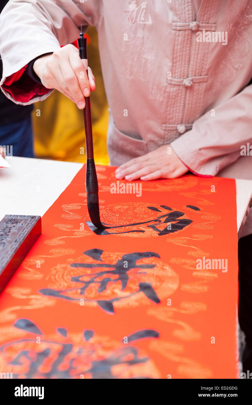 The man writing Chinese spring festival couplets Stock Photo