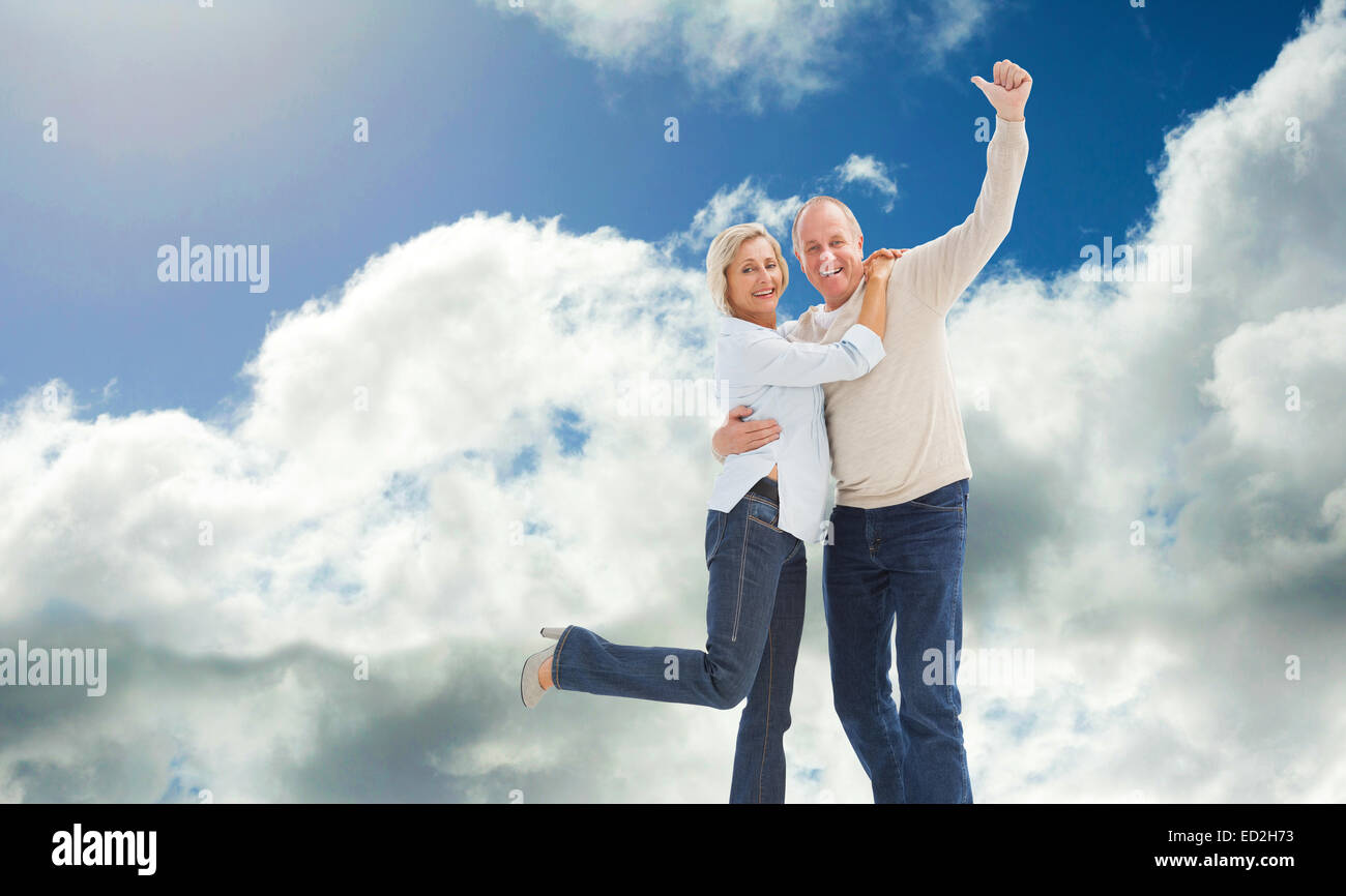 Composite image of happy mature couple cheering at camera Stock Photo ...