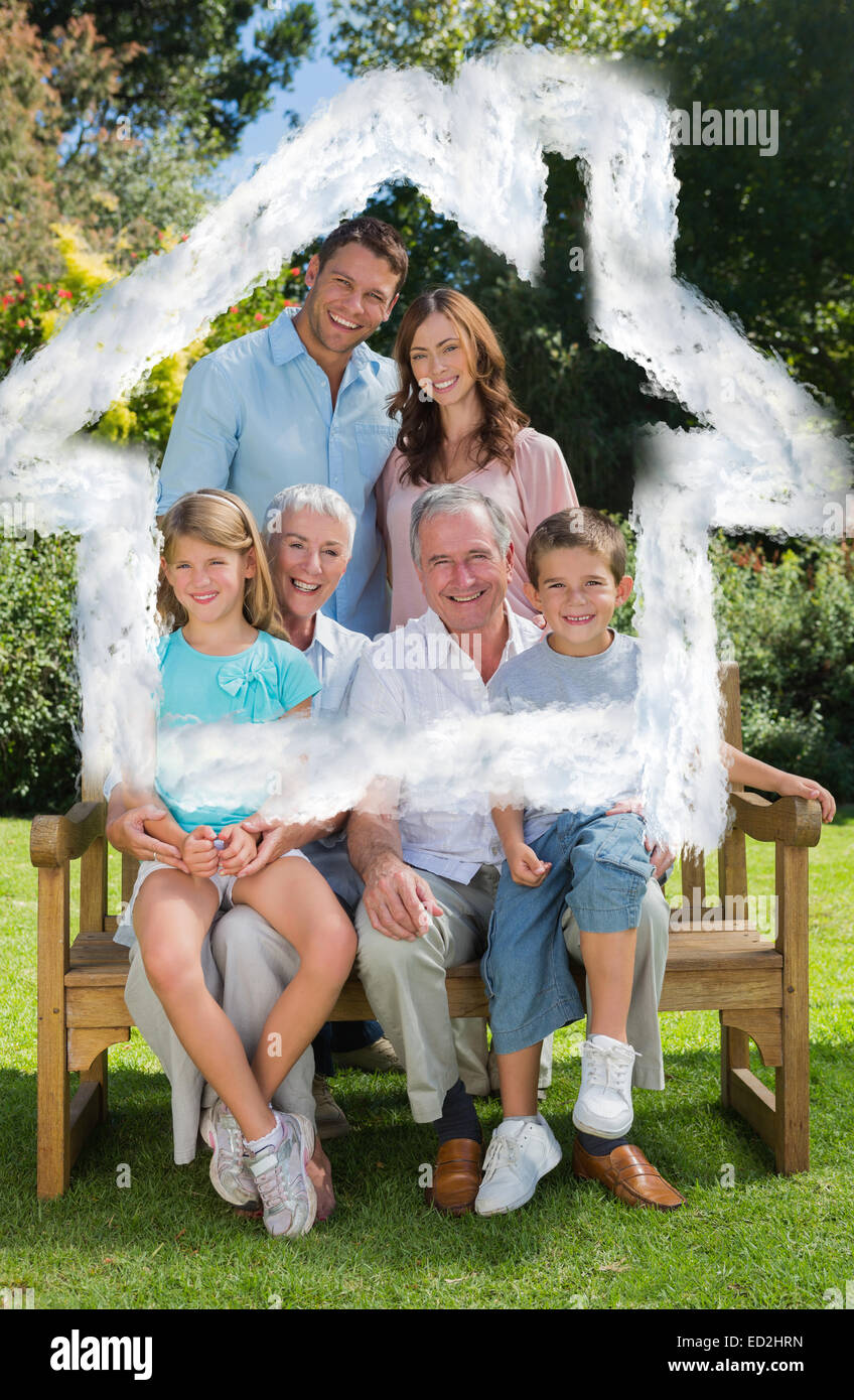 Composite image of smiling multi generation family sitting on bench in park Stock Photo