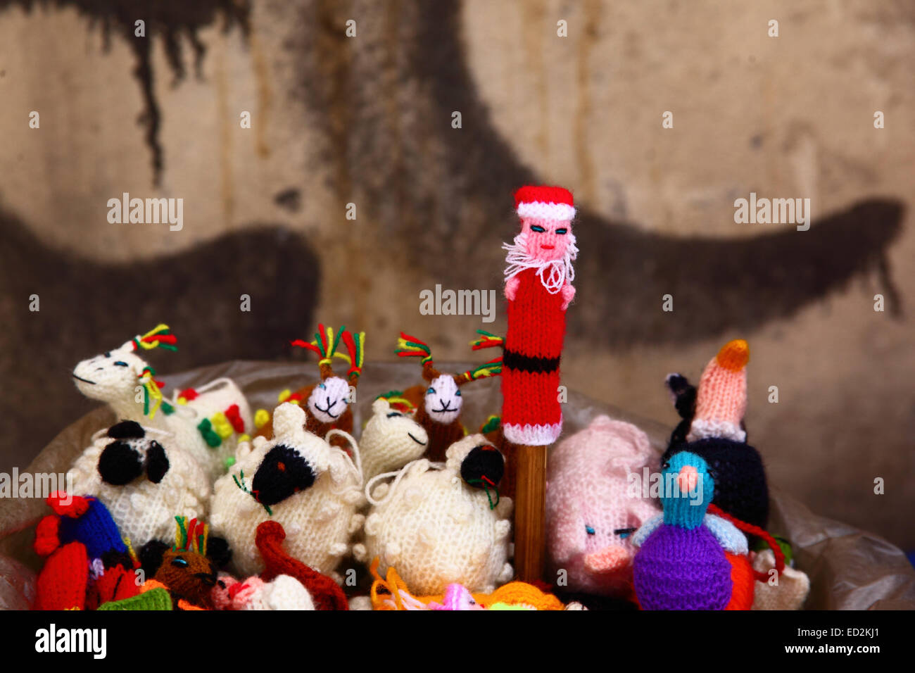 La Paz, Bolivia, 24th December 2014. Woolen Father Christmas, llama and sheep finger puppets for sale on a street stall in the tourist market area. Credit:  James Brunker / Alamy Live News Stock Photo