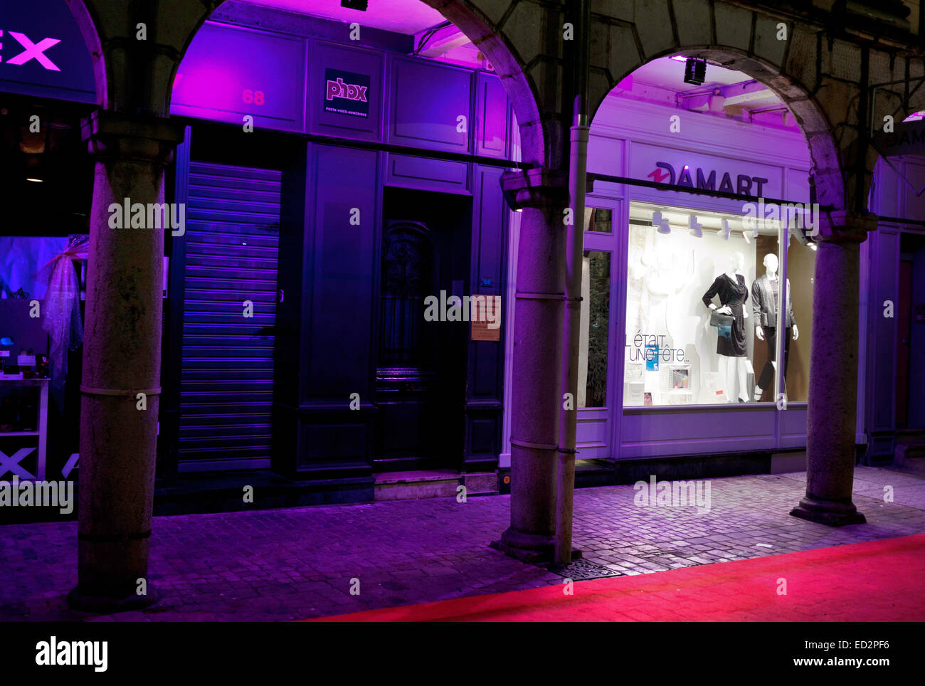 Purple lit shops in arcade, Arras Stock Photo