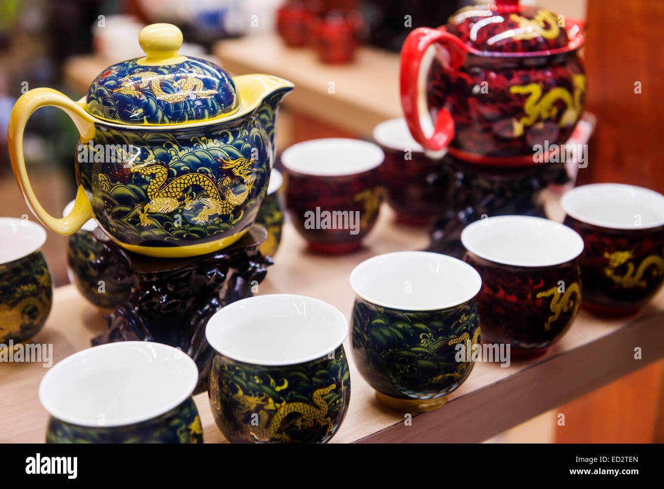 Chinese tea sets, painted decorative teapots and cups on display at a