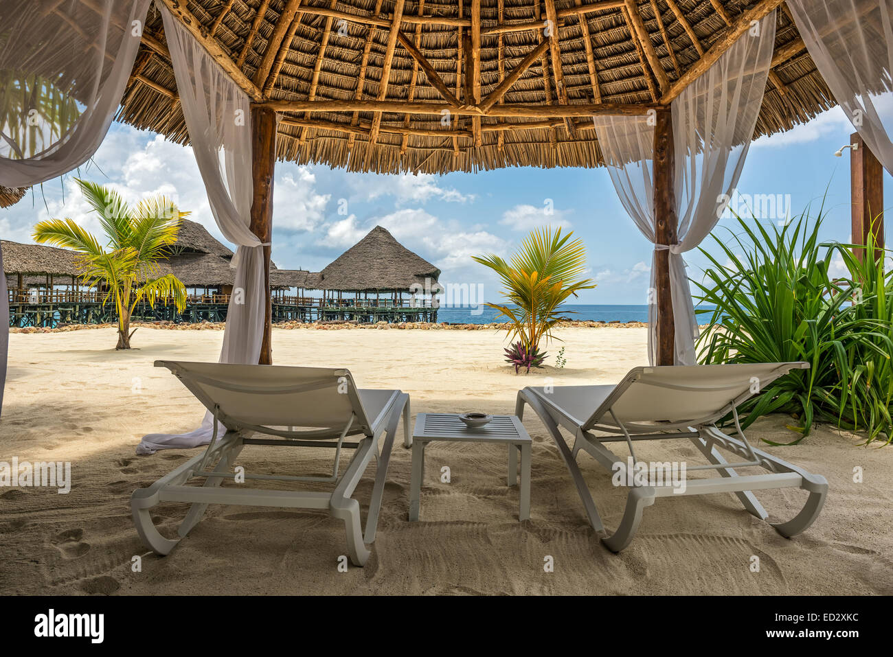 Beach lounge chairs and a beach bar at the shore of Indian ocean, Zanzibar, Tanzania Stock Photo