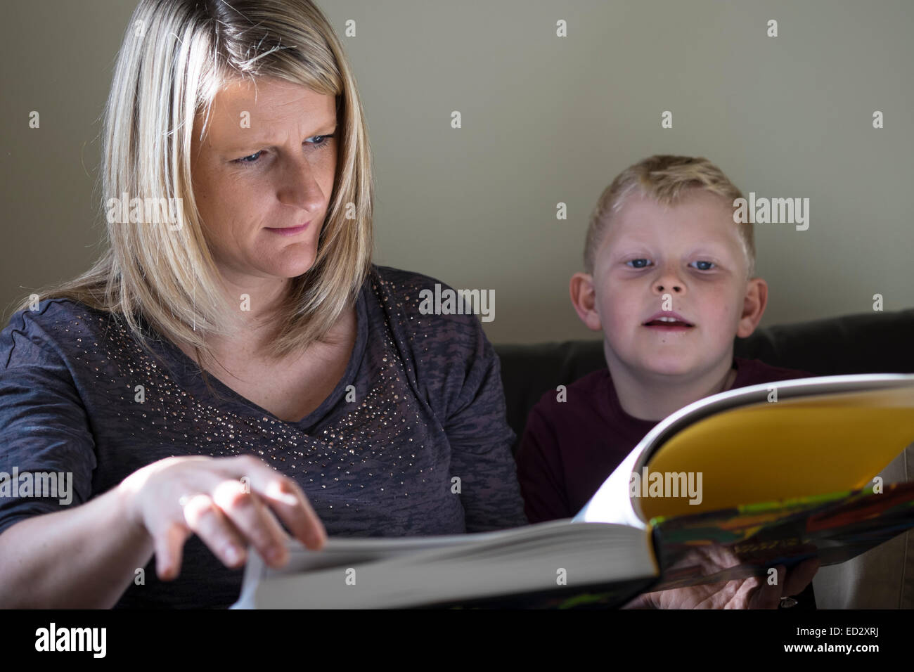 Mum reading son a book Stock Photo