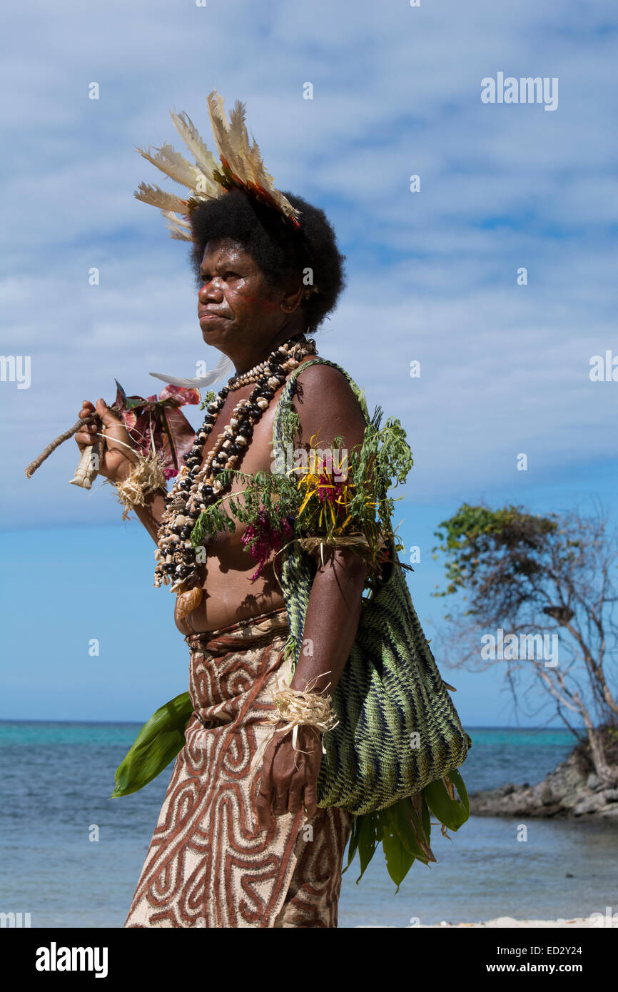 Melanesia, Papua New Guinea, Tufi. Woman on beach dressed in typical sing-sing native attire. Stock Photo