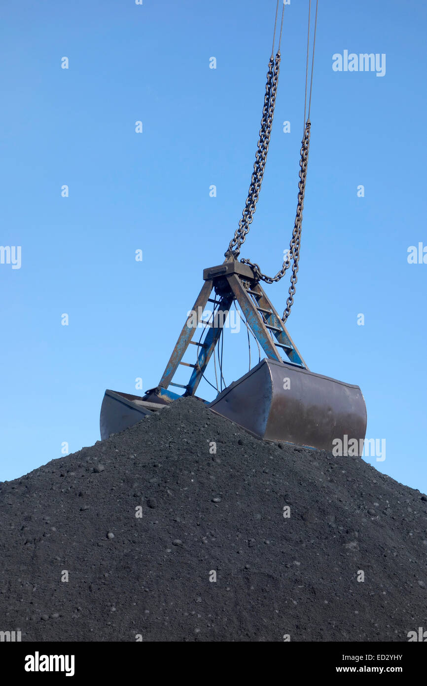 The top of a huge coal pile with clamshell bucket Stock Photo