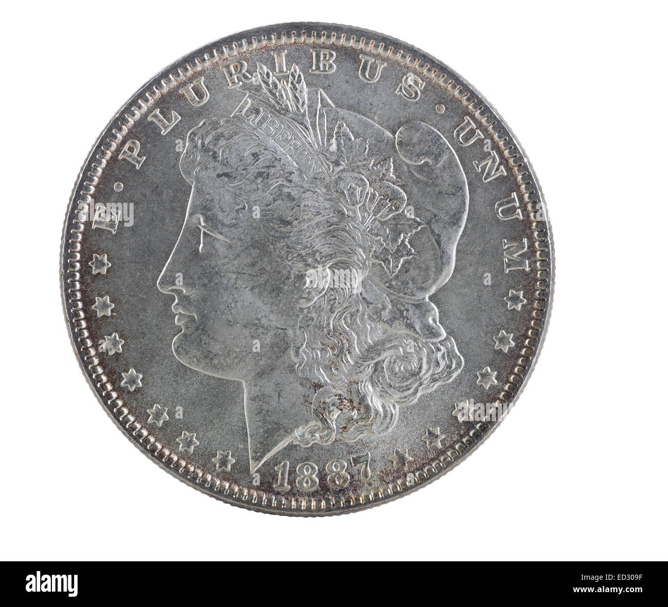 Extreme close up of an American Morgan Silver Dollar, with full rim edge and natural toning, isolated on white Stock Photo
