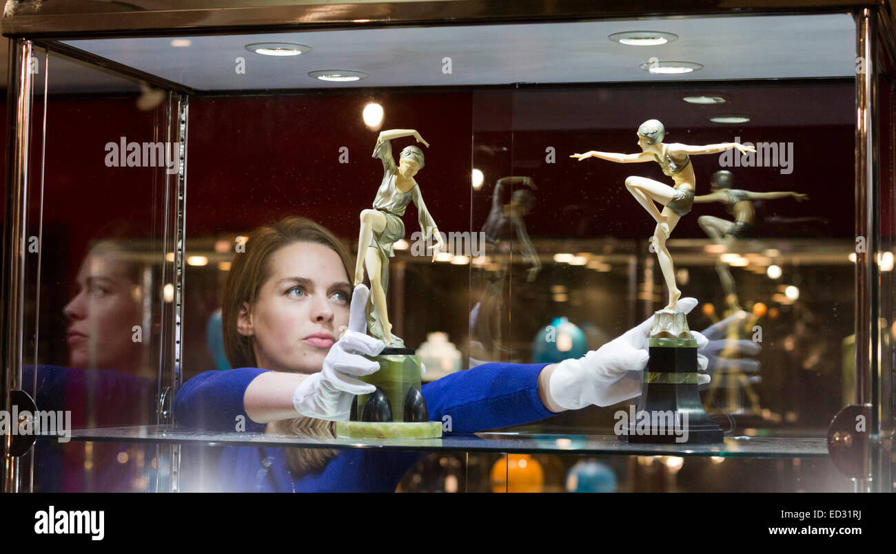 London, UK. 17 November 2014. A Bonhams employee holds two statuettes by Ferdinand Preiss.  Preview of the Bonhams Decorative Arts Sale from 1860. Sale takes place on 19 November 2014. Stock Photo