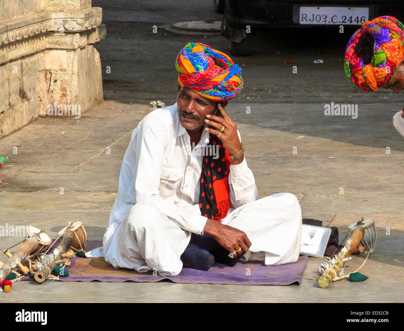 street musician with  mobile in udaipur india Stock Photo