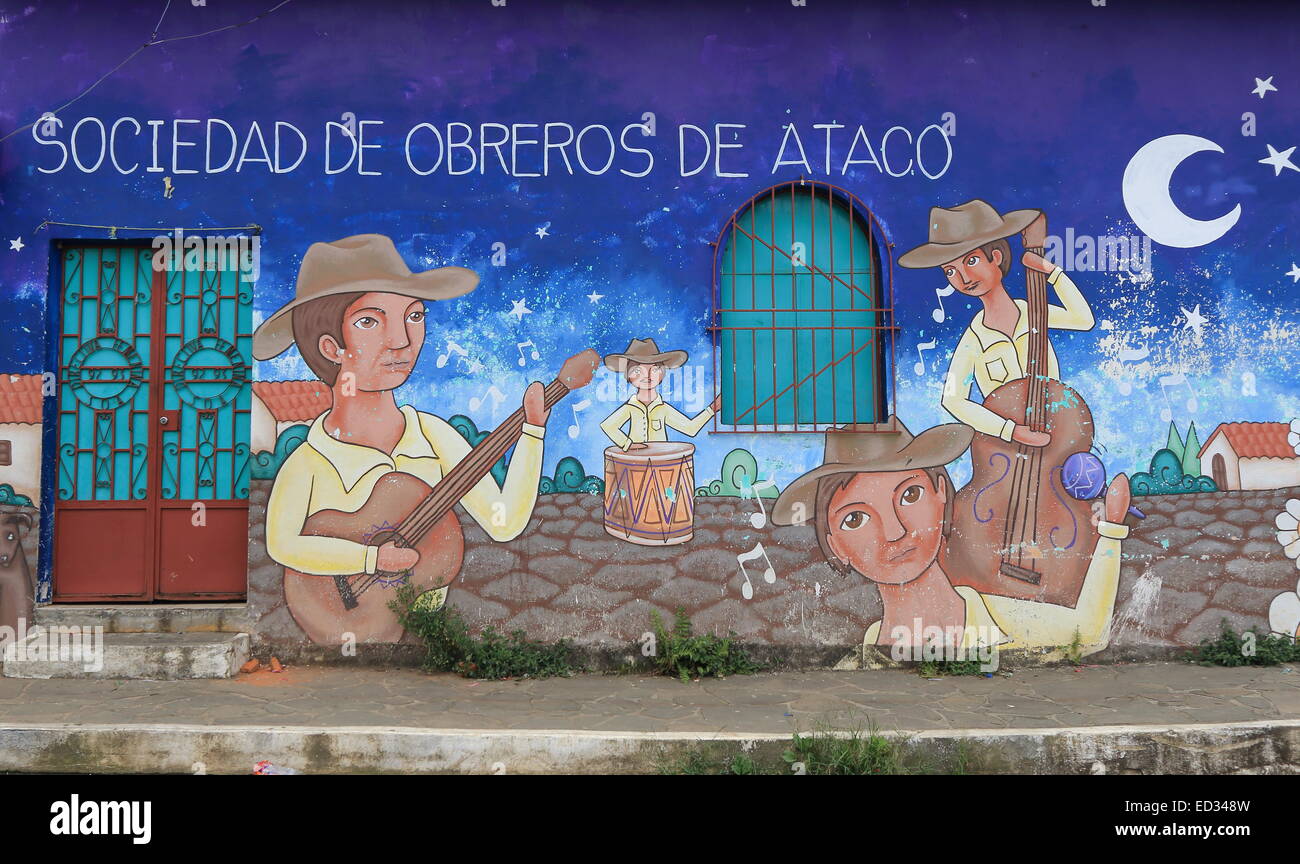 A brightly coloured mural painted on the walls of a street in Ataco, with slogan in Spanish. Ataco, Ahuachapán, El Salvador. Stock Photo