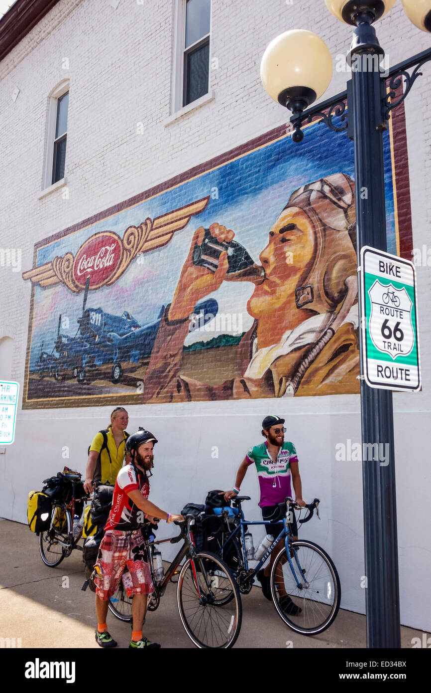 Illinois Pontiac,sign,historic highway Route 66,bike trail,man men male,friends bikers,bicycles,mural,Coca-Cola,IL140905037 Stock Photo