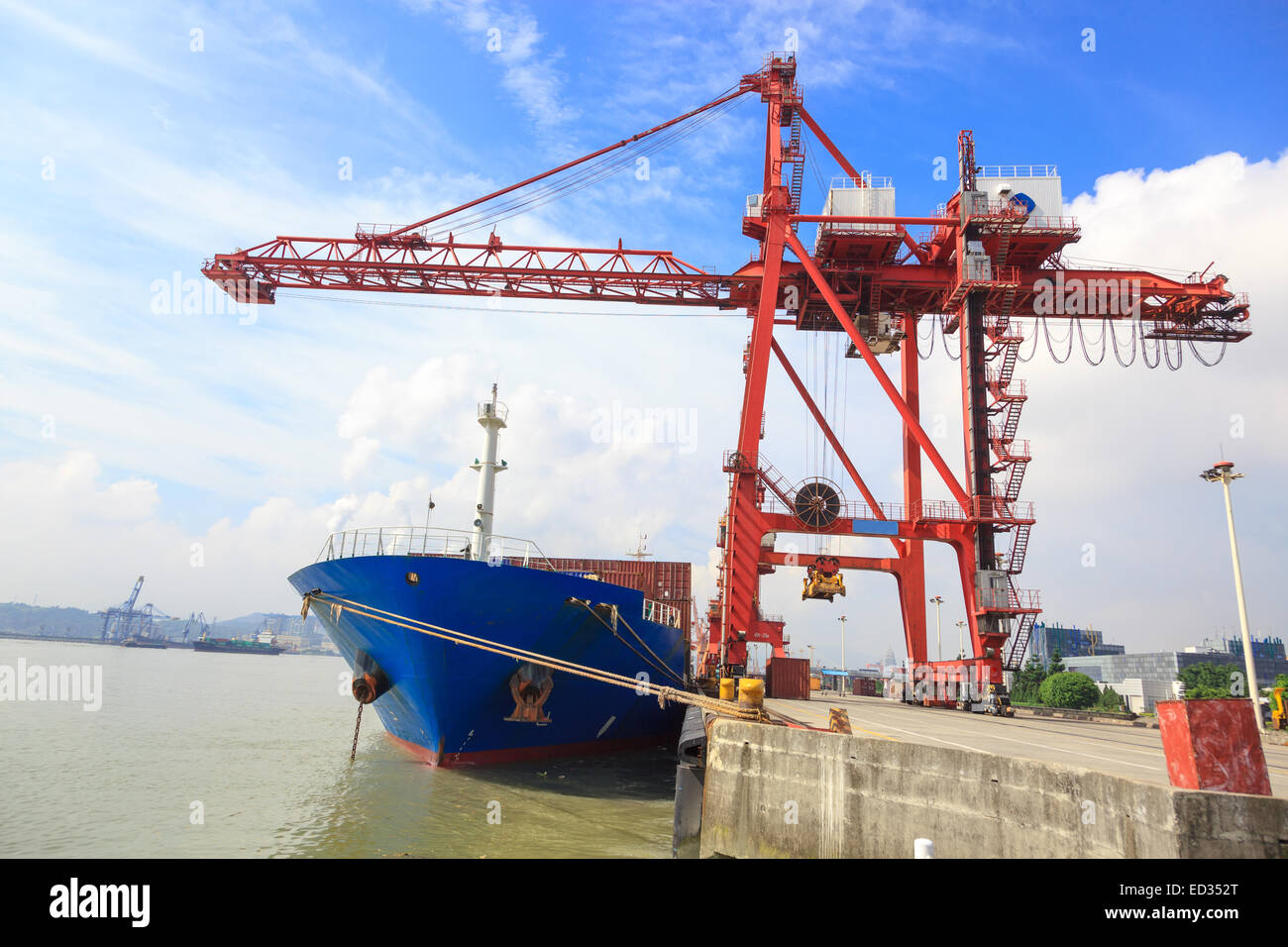 Frontal view of a container ship with a gantry cranes loading cargo ...