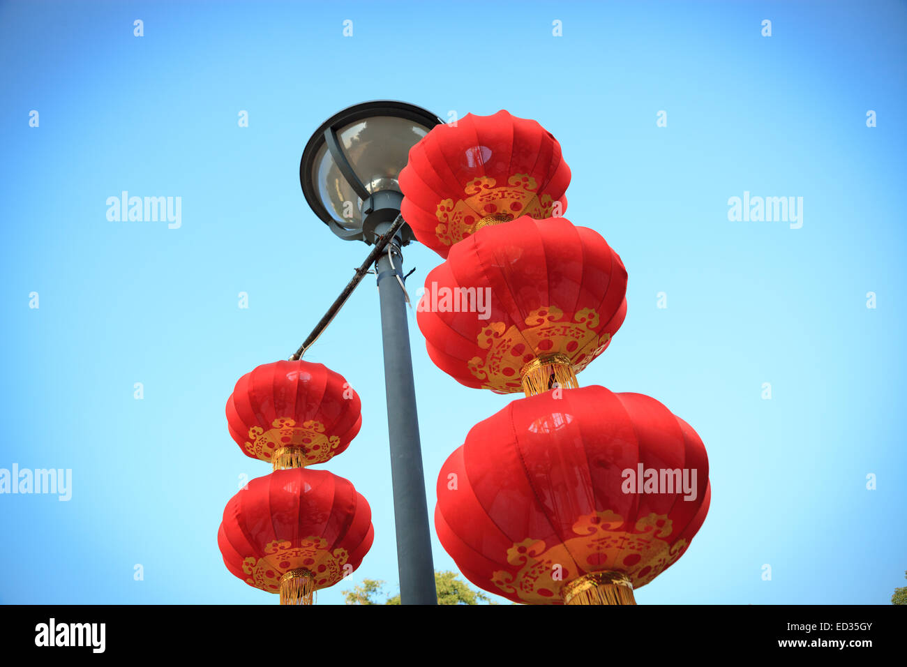 Chinese red lanterns hanging on the streetlight by the blue sky ...