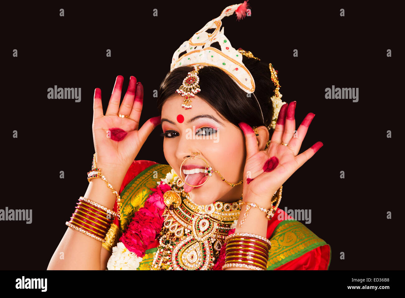 Photo of An elegant bridal shot in Bengali saree and temple jewellery.