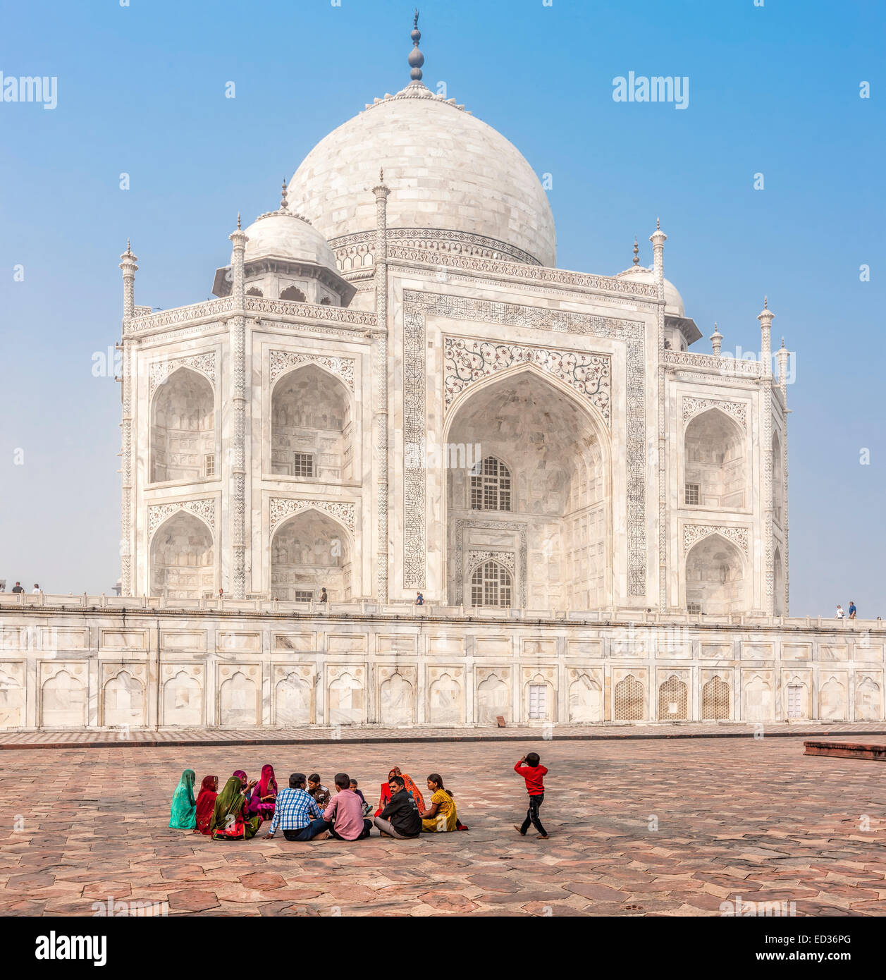 AGRA, INDIA - NOV 17, 2012: People relax around the walls of the Taj Mahal. Taj Mahal recognized as jewel of Muslim art in India Stock Photo