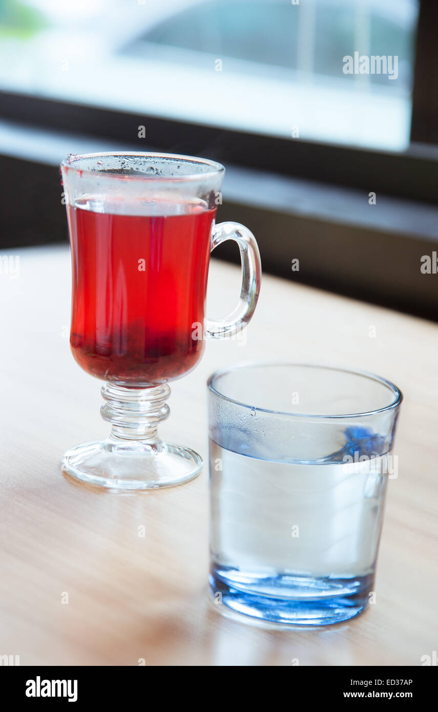 Red cranberry fruit drinks and vodka in glass on table Stock Photo