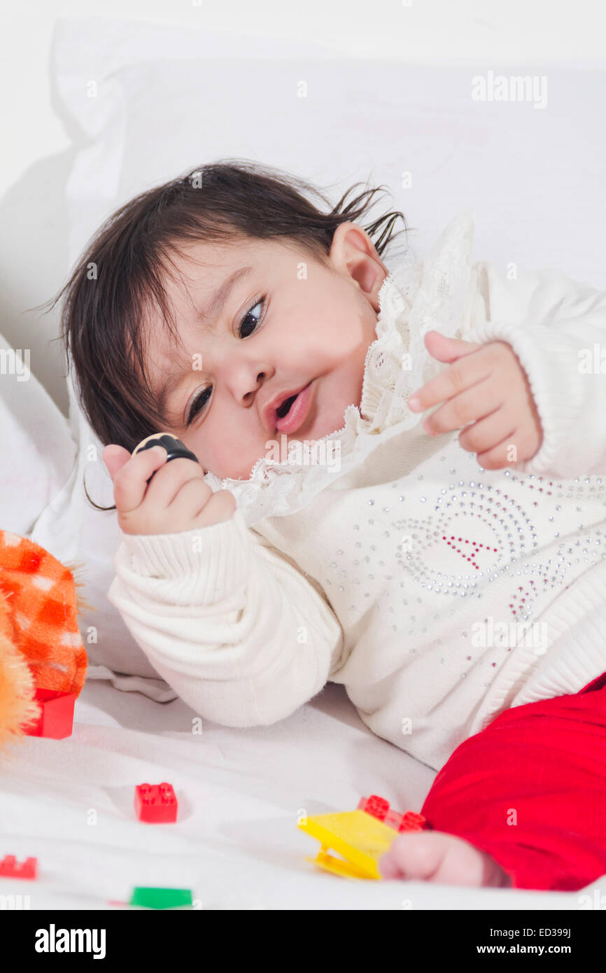 1 indian child Baby Bedroom playing toy Stock Photo