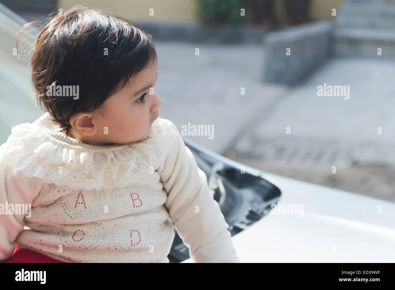1 indian child Baby sitting car Stock Photo
