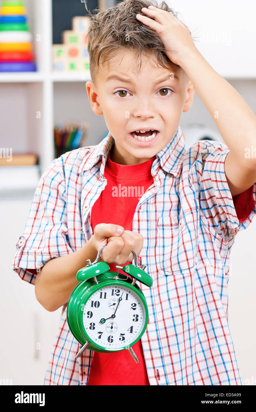 Boy with alarm clock Stock Photo Alamy