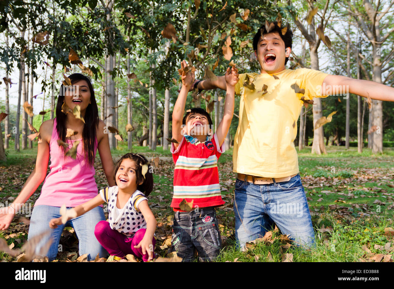 indian Parents with children  park enjoy Autumn Stock Photo