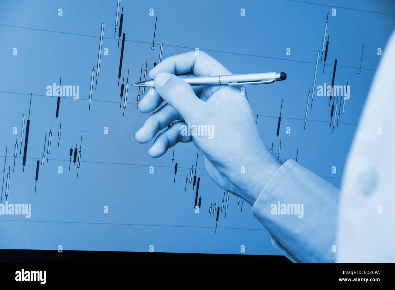 candlestick chart analysis with hand and pen Stock Photo