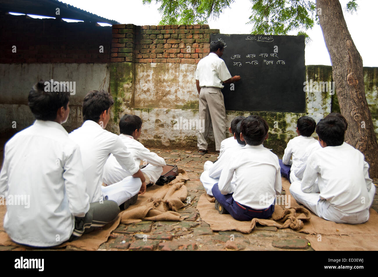 indian rural Teacher man Teaching Children Stock Photo